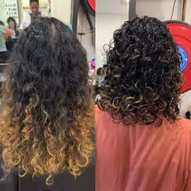 Brunette curly hair receiving Mane Glow curl definition treatment with steamer and cutting off damaged ends. Significant length of split, dry, and broken ends being removed while curls are defined, hydrated, and transformed with steam therapy for a fresh, healthy start.